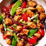 Delicious Kung Pao Chicken with peanuts and peppers served in a bowl