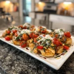 Delicious Bruschetta Chicken Bake topped with fresh tomatoes and basil