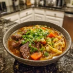 Delicious bowl of Korean Beef Noodles with savory broth and tender meat.