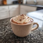 Cozy creamy crockpot hot chocolate topped with whipped cream and chocolate shavings