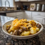 Cozy Slow Cooker Steak and Cheddar Potato Casserole ready to serve