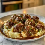 Salisbury Steak Meatballs served on a plate with rich gravy and fresh parsley.